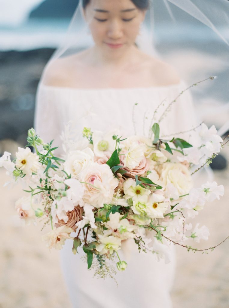 creme bridal bouquet on the beach in Hawaii