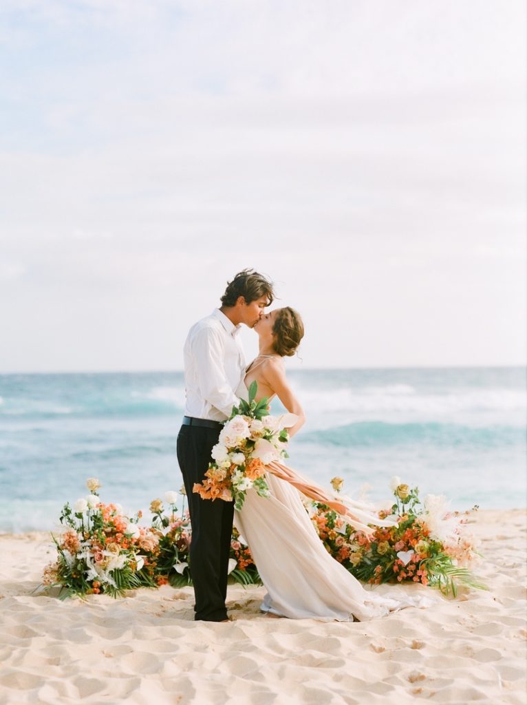 Hawaii Beach Wedding with tropical ceremony flowers

