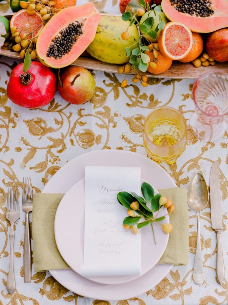 Tropical place setting with fruit and flowers
